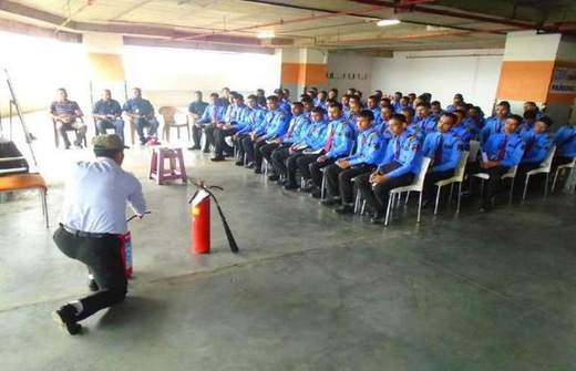 Extinguisher demonstration to a seated cohort